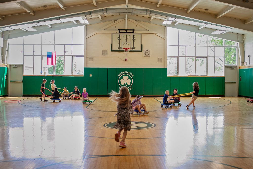 Students inside a gymnasium playing