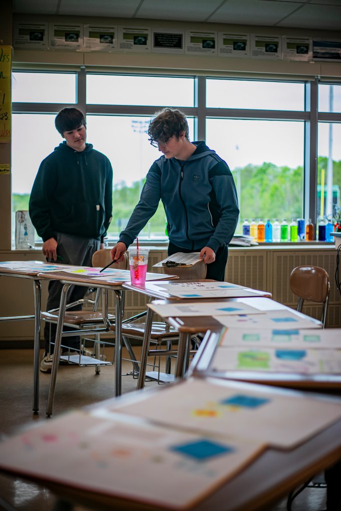 Two students conducting experiment in classroom